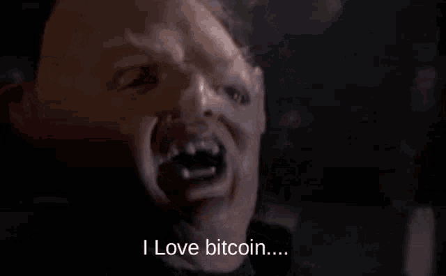 a close up of a man 's face with a mask on and the words `` buy my shitcoin '' .