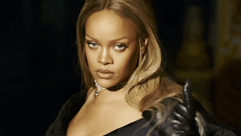 a close up of a woman wearing a black top