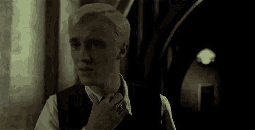 a man in a suit and tie is walking down a hallway .