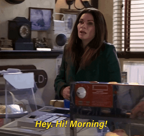 a woman in a green coat says " hey hi! morning "