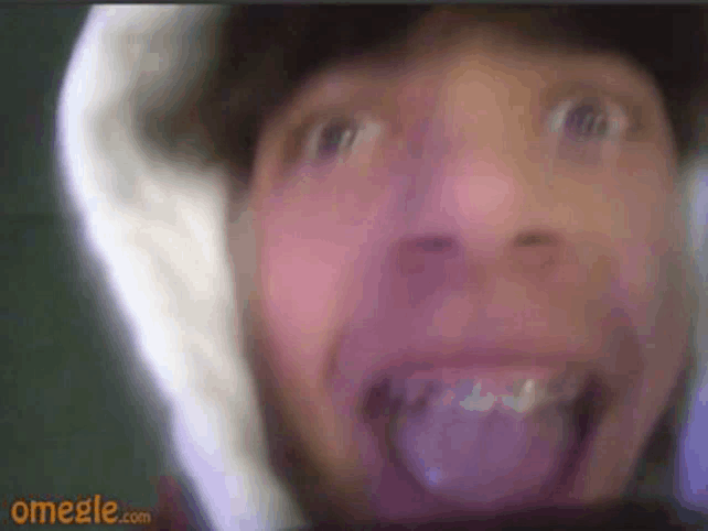 a close up of a man 's face with omegle.com in the corner
