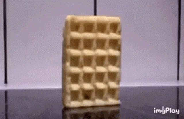 a close up of a waffle on a table with imgplay written on the bottom