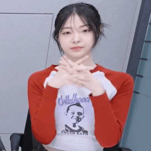 a girl wearing a shirt that says childhood youth bath crosses her arms
