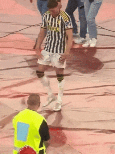 a man in a black and white striped shirt that says ' juventus ' on it