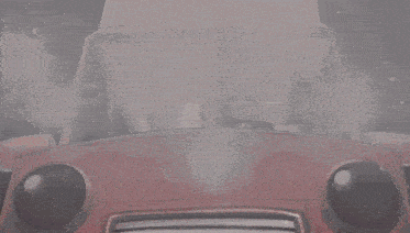 a cartoon character is driving a red car with a smiley face on the windshield