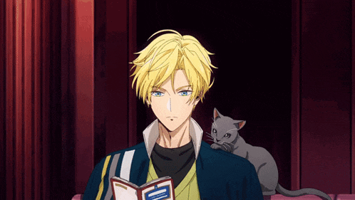 a man is reading a book with a cat laying on his shoulder
