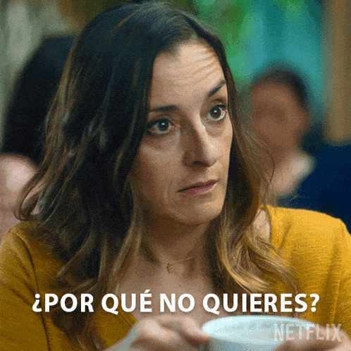a woman in a yellow sweater is holding a cup of coffee and asking " por que no quieres "