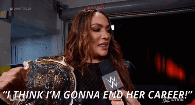 a woman is holding a wrestling championship and says " i think i 'm gonna end her career "
