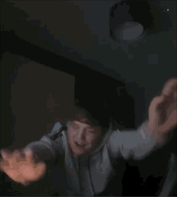 a blurry photo of a person with a green light on the bottom right