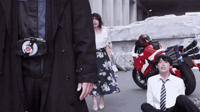 a man in a suit and tie is sitting in front of a motorcycle