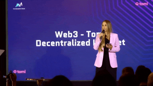 a woman stands in front of a large screen that says web3 tor decentralized