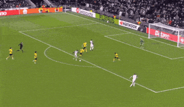 a soccer game is being played in front of a sign that says ' strauss '