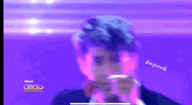 a blurry picture of a man with a purple background that says want usq