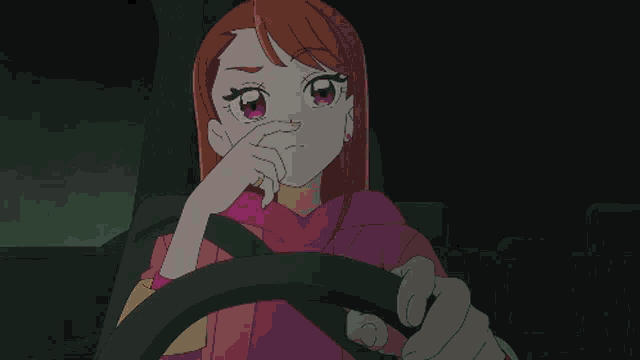 a girl in a pink hoodie is driving a car