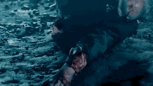 a man is laying on his back on the ground with blood on his face .