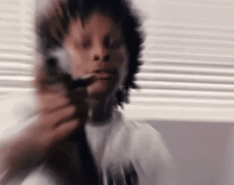a blurry picture of a person holding a gun .