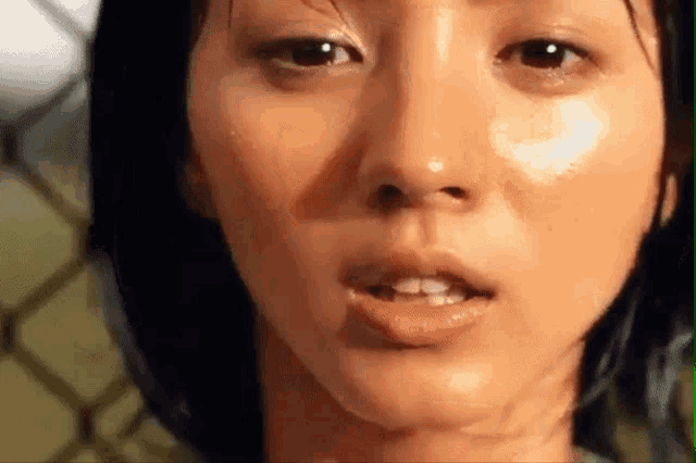 a close up of a woman 's face with sweat on it