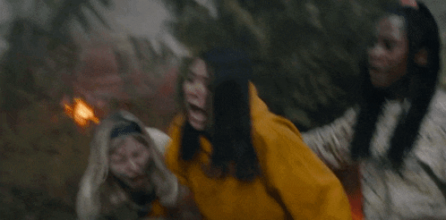 a woman wearing a yellow hoodie with the word lakers on it screams