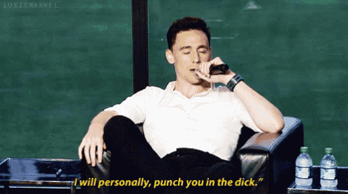 a man is sitting in a chair talking on a cell phone and says " i will personally punch you in the dick "