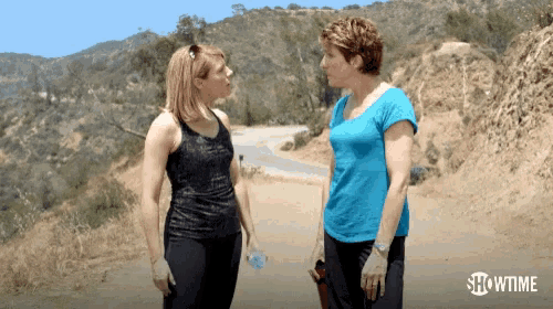 two women standing next to each other with showtime written on the bottom right