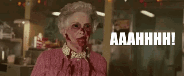 an elderly woman with blood on her face is screaming in a diner with the words aaahhhh written above her .