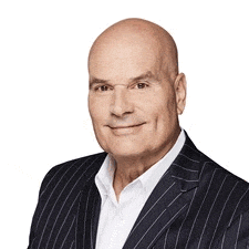 a bald man wearing a suit and white shirt is smiling for the camera .
