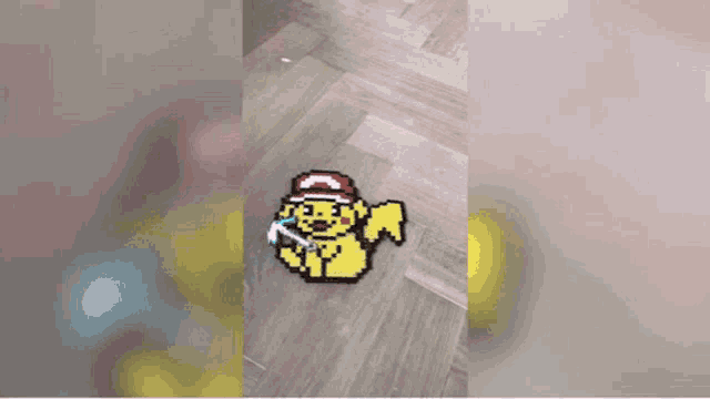 a person is making a pokemon with beads on the floor