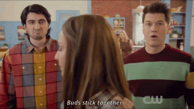 two men and a woman are standing in a room and the woman says buds stick together