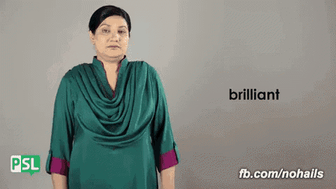 a woman in a green shirt is making a sign that says " brilliant "