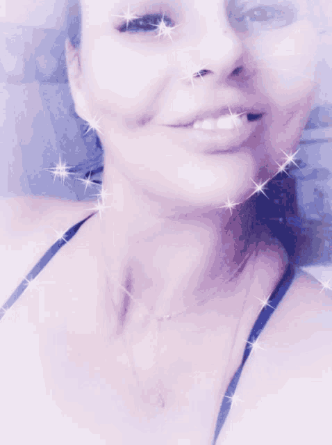 a close up of a woman 's face with sparkles
