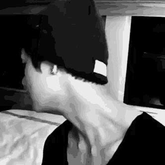 a black and white photo of a person wearing a beanie .
