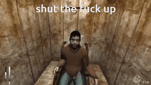 a man is sitting in a chair with the words shut the fuck up above him