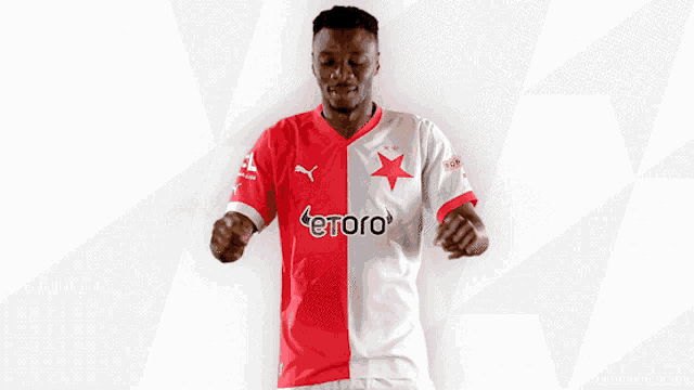 a man wearing a red and white jersey with etoro written on it
