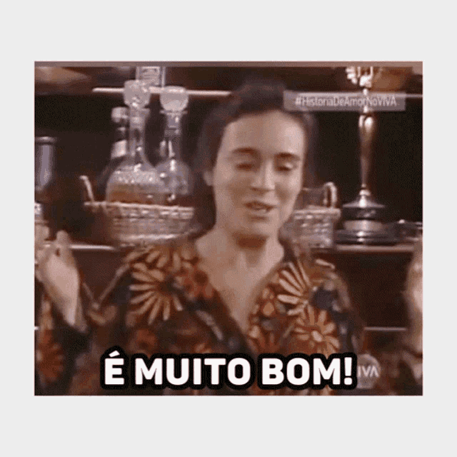 a woman in a floral shirt says " e muito bom " in a foreign language