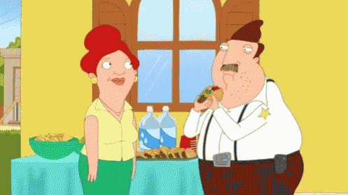 a man in a sheriff 's uniform is eating a hot dog while a woman looks on