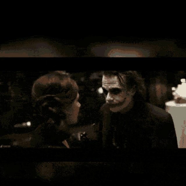 the joker is holding a knife and says come here i 'll put smile on your face