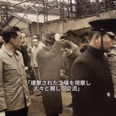 a group of men are standing in a line with chinese writing on the bottom right