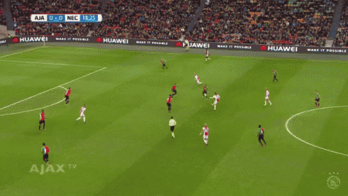 a soccer game is being played on a field with huawei advertisements on the sidelines