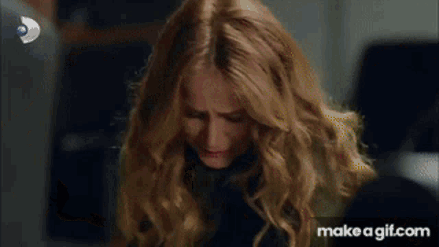 a group of people are looking at a person laying on the floor with make a gif.com at the bottom