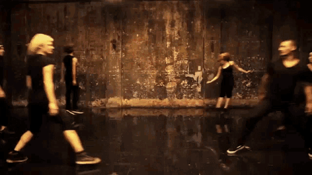 a group of people dancing in a dark room