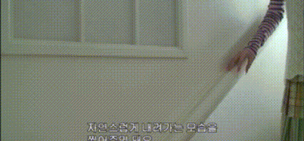 a woman 's face is visible in a blurry photo with korean writing on the bottom right corner .