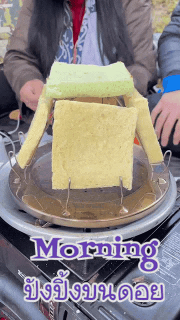 a person is cooking a sandwich on a stove with the words morning written on the bottom
