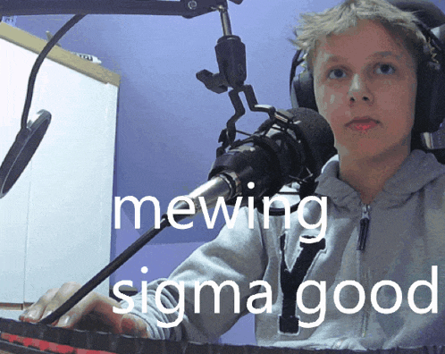 a boy wearing headphones is sitting in front of a microphone with the caption mewing sigma good