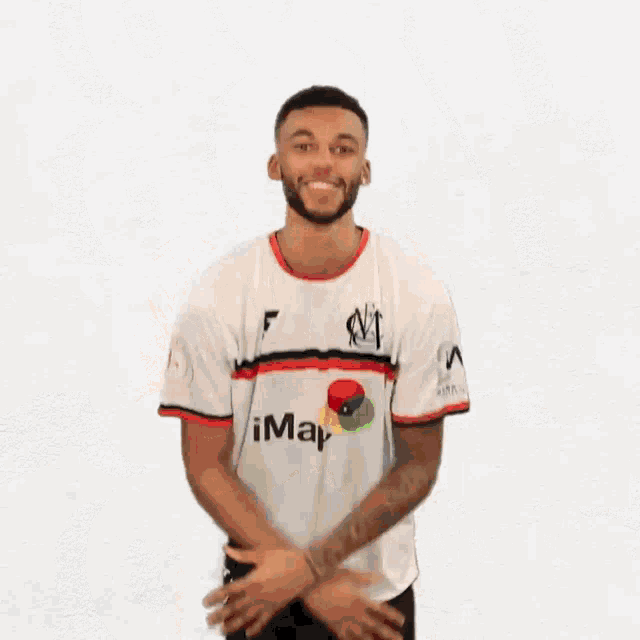 a man wearing a white shirt that says imap on it