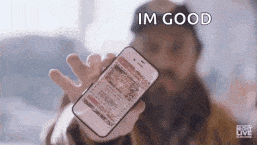 a person is holding a broken cell phone in their hand and saying `` im good '' .