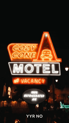 a neon sign for the cozy cone motel says no vacancy