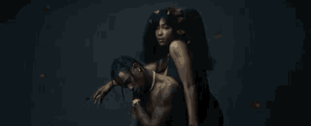 a man is sitting on a woman 's lap in a dark room .