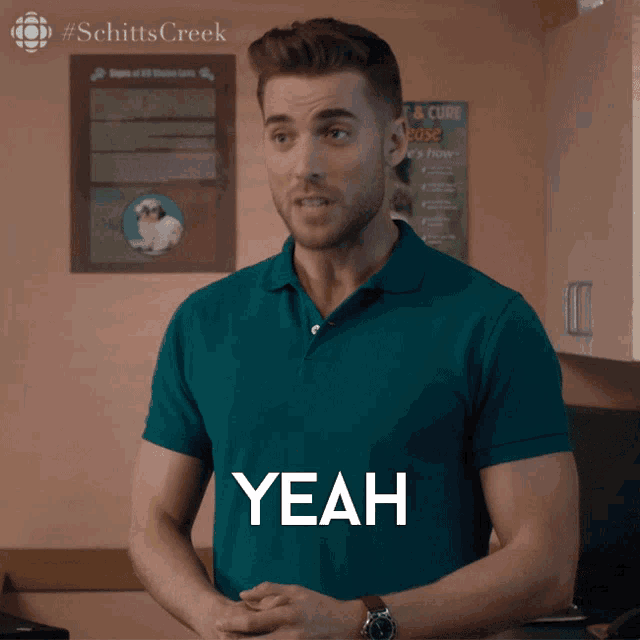 a man wearing a blue shirt says yeah