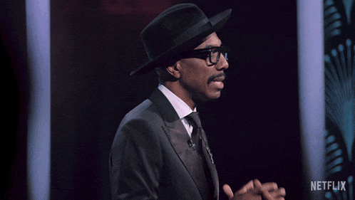 a man with glasses and a hat says it 's all love baby
