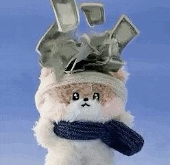 a teddy bear wearing a scarf and a hat with money falling from the sky .